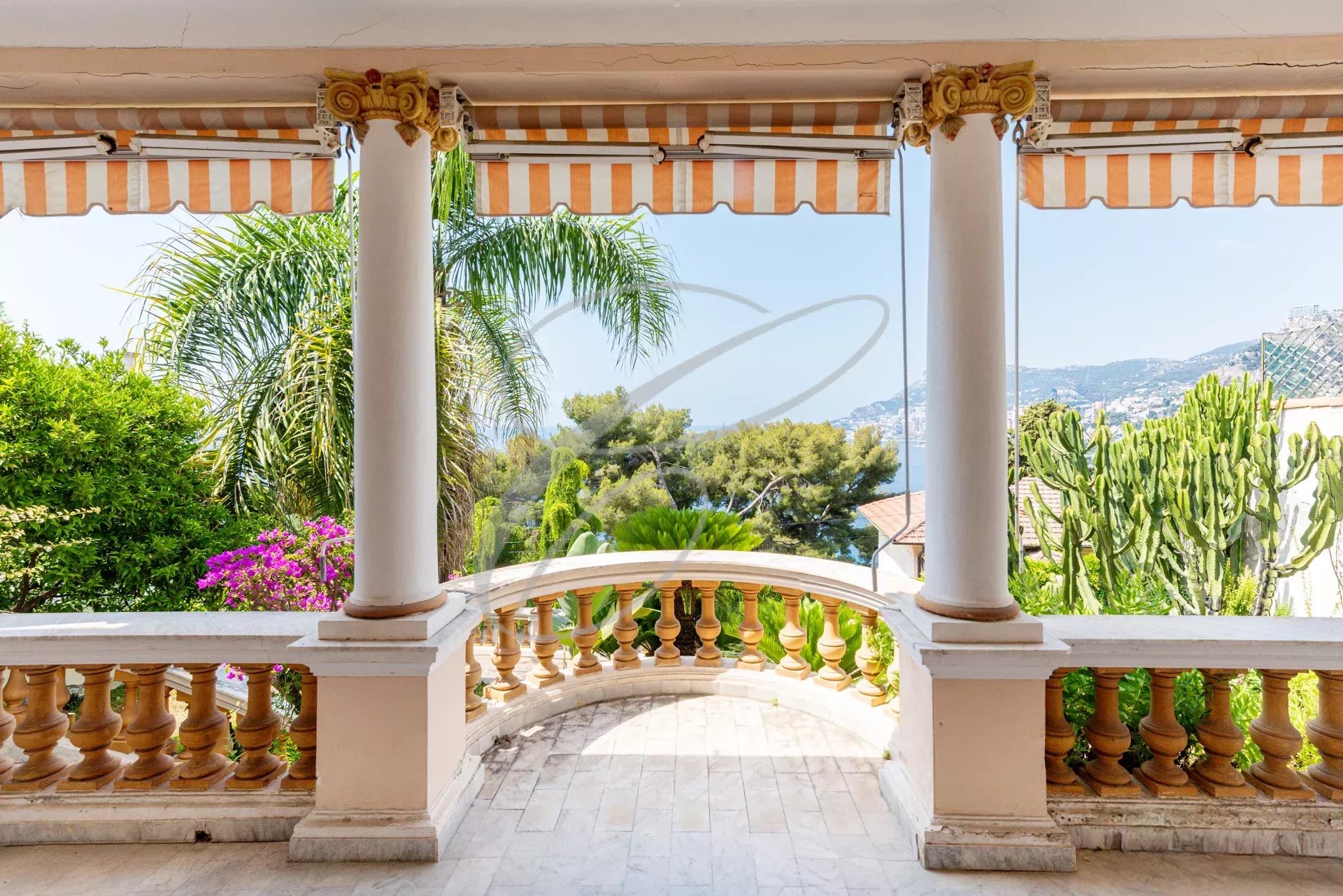 Terrace with a view in Roquebrune-Cap-Martin View from a terrace with columns, plants and the sea on the horizon in Roquebrune-Cap-Martin.