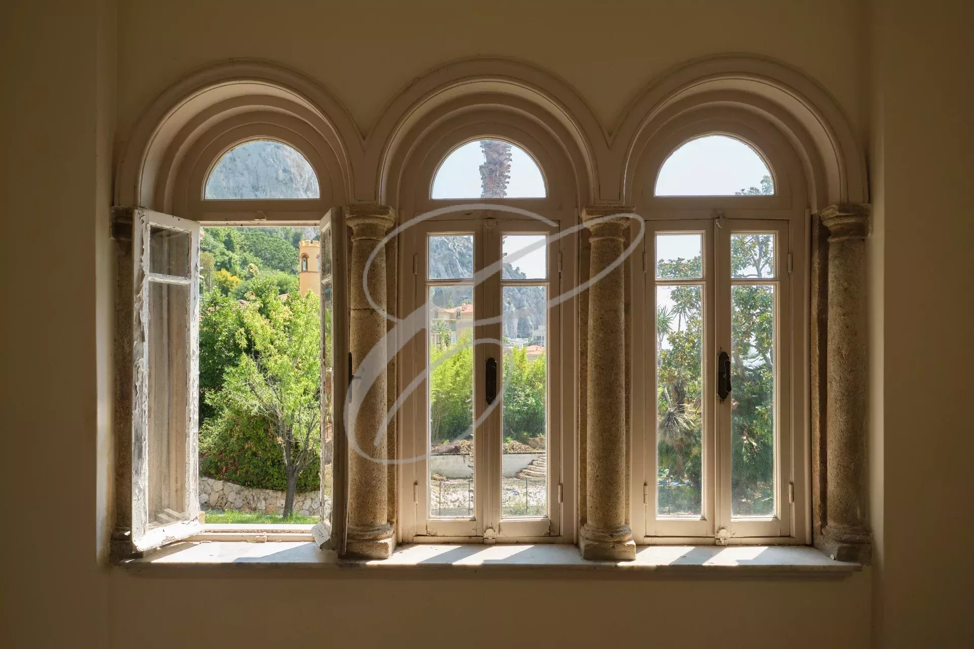 Villa windows in Menton Garavan View from arched windows with an exotic garden in the background.