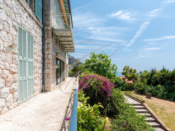 View from the terrace of a stone villa with flowers, Menton Garavan.