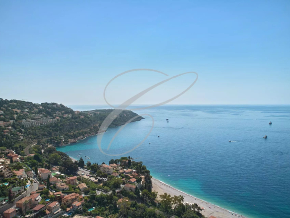 Vue panoramique sur la mer et la côte depuis Roquebrune-Cap-Martin, avec des maisons en bord de mer.