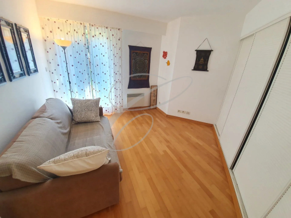 Interior of an apartment with a sofa and a wooden floor.