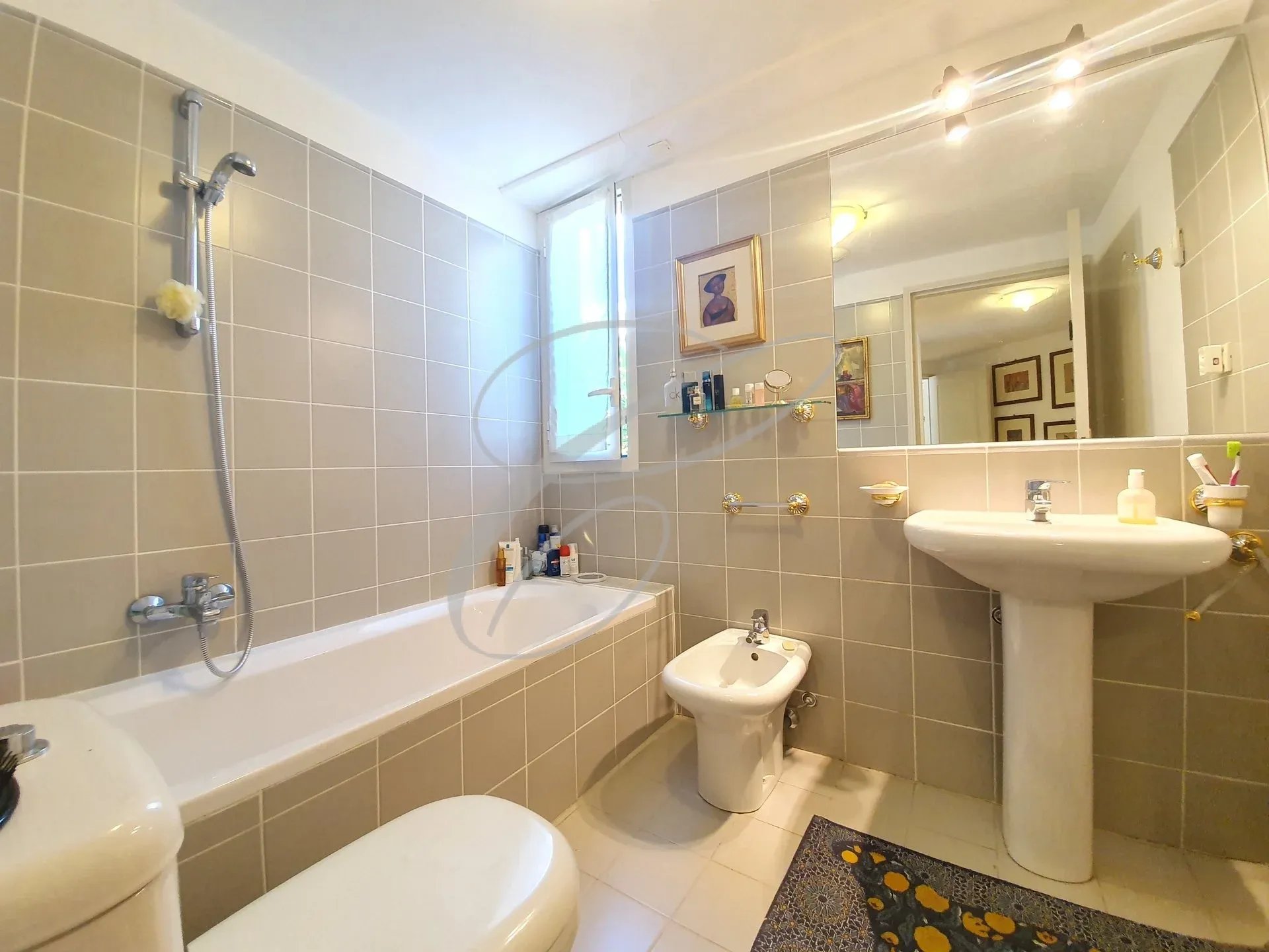 Bathroom of an apartment Bathroom in an apartment with bathtub, bidet and sink.