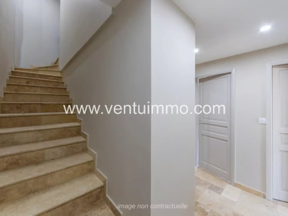 Interior of a terraced house with marble staircase and light walls in Mougins.