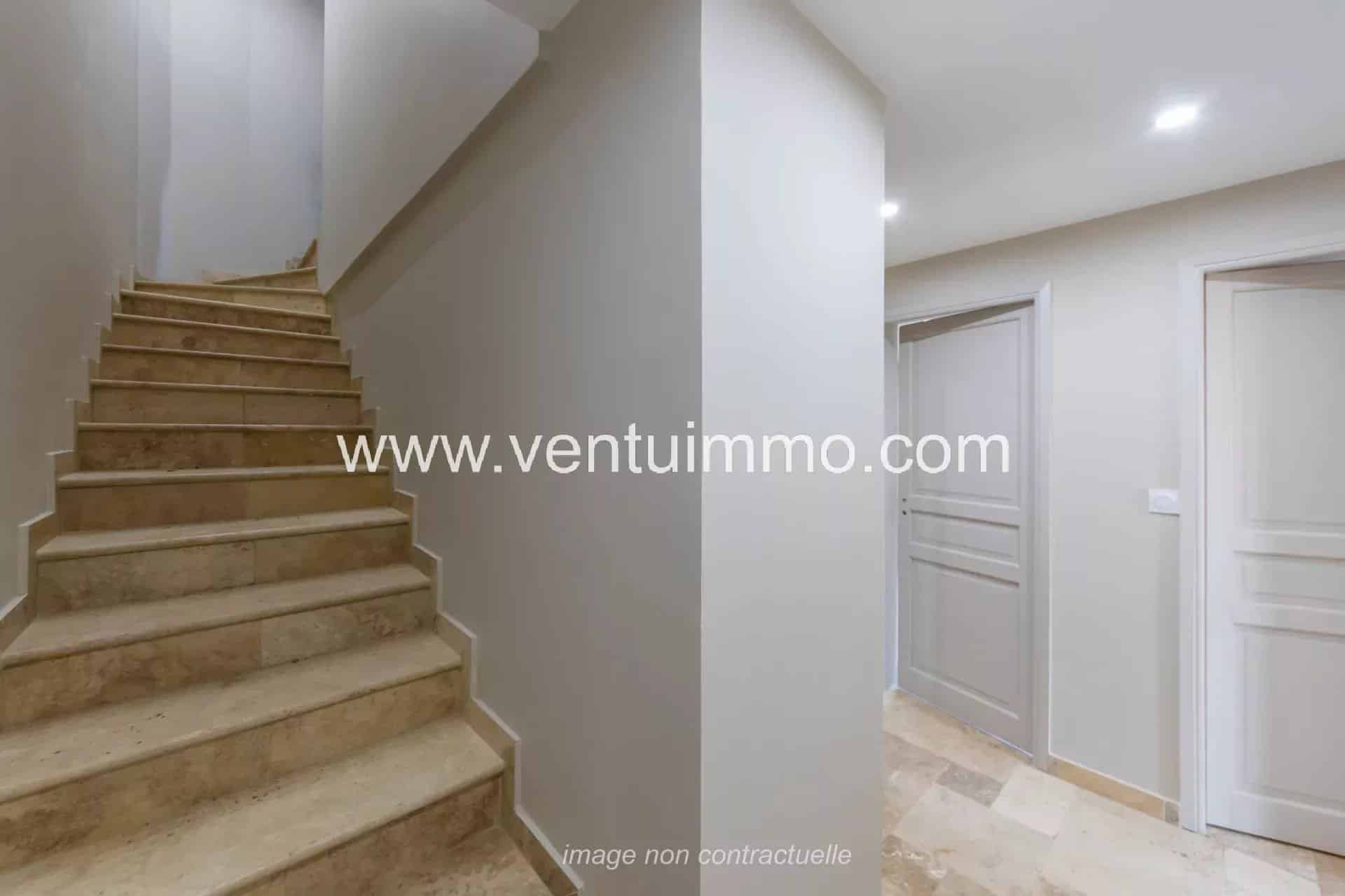 Interior of a terraced house with marble staircase and light walls in Mougins.