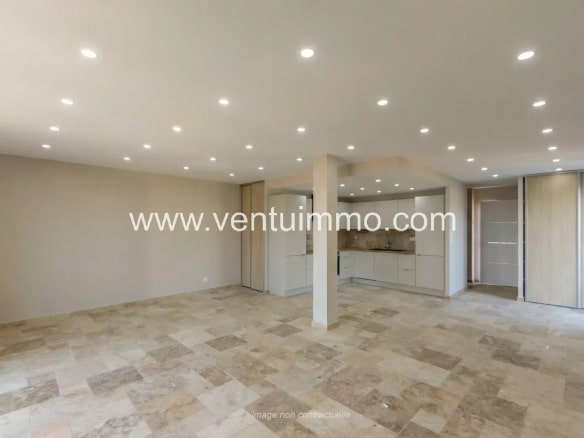 Interior of a modern terraced house with stone flooring and recessed lighting.
