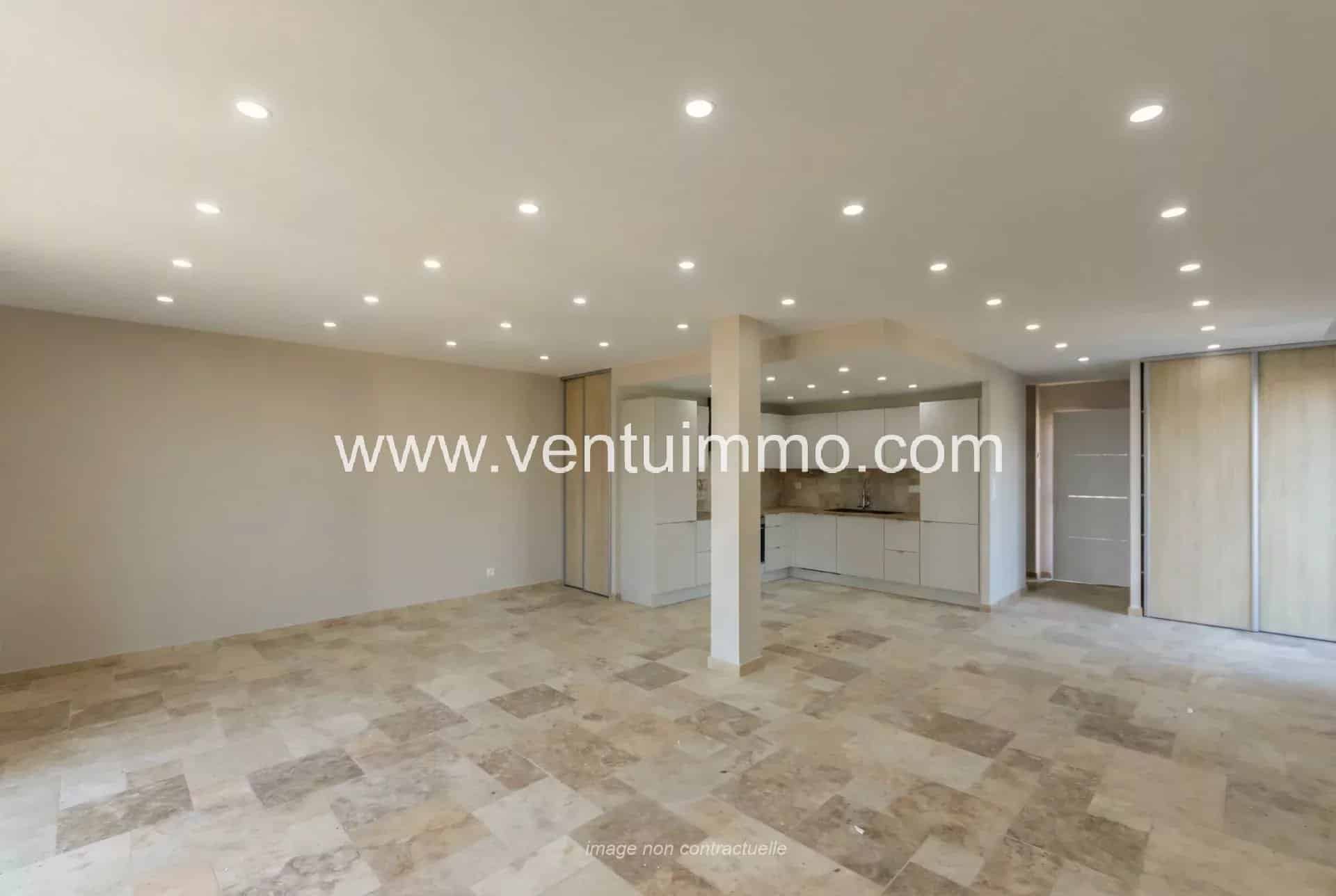 Interior of a modern terraced house with stone flooring and recessed lighting.