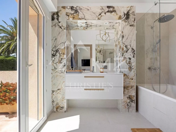 Modern bathroom with marble, bathtub and shower.