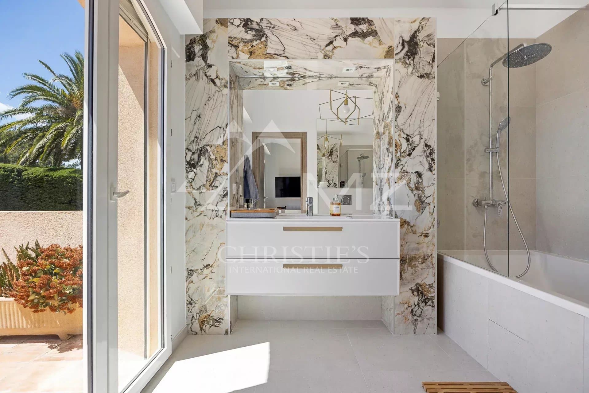 Modern bathroom with marble, bathtub and shower.