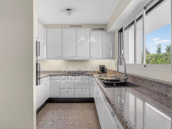 Spacious and bright kitchen in a Cannes penthouse with granite worktops.