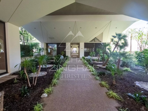 Entrance to a modern building with a landscaped garden in Cannes.