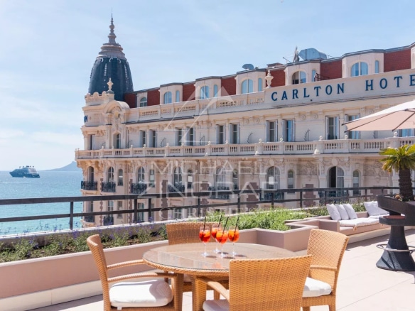 Terrace of a penthouse in Cannes with a view of the sea and the Carlton Hotel.
