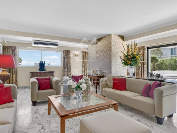 Interior of a penthouse in Cannes with a bright living room and sea view.