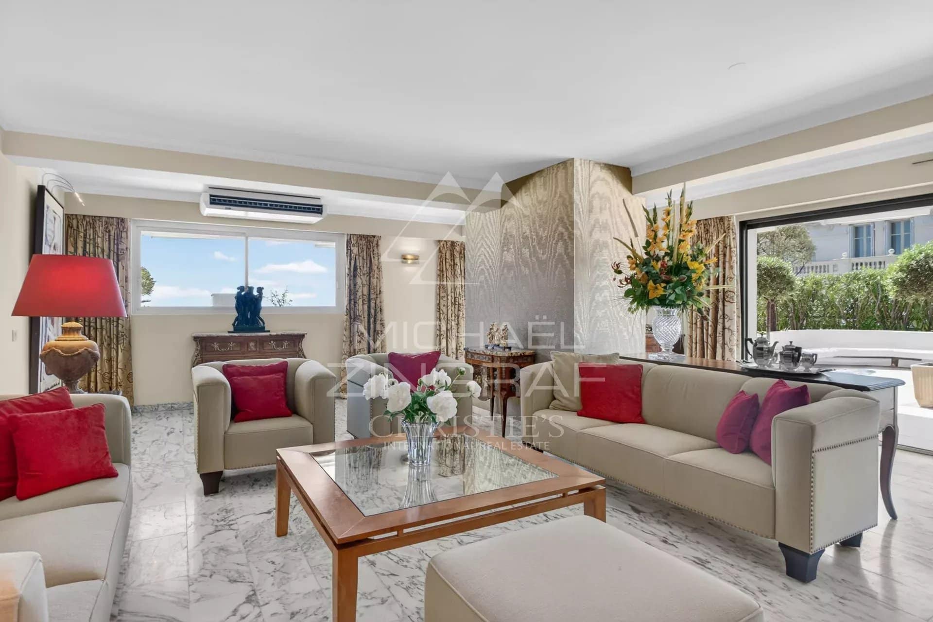 Interior of a penthouse in Cannes with a bright living room and sea view.