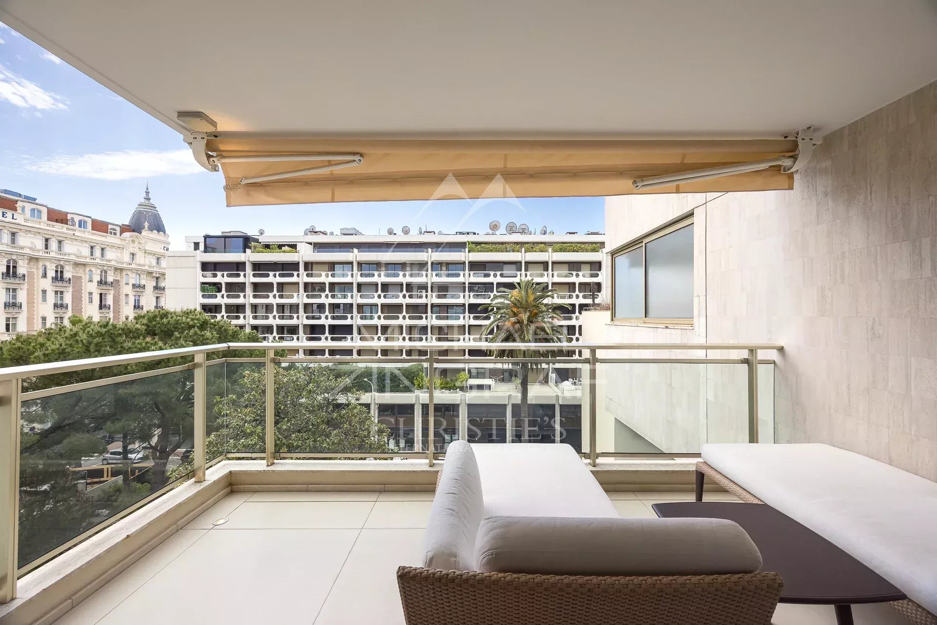 Apartment balcony in Cannes Balcony of an apartment in Cannes with views of buildings and trees.