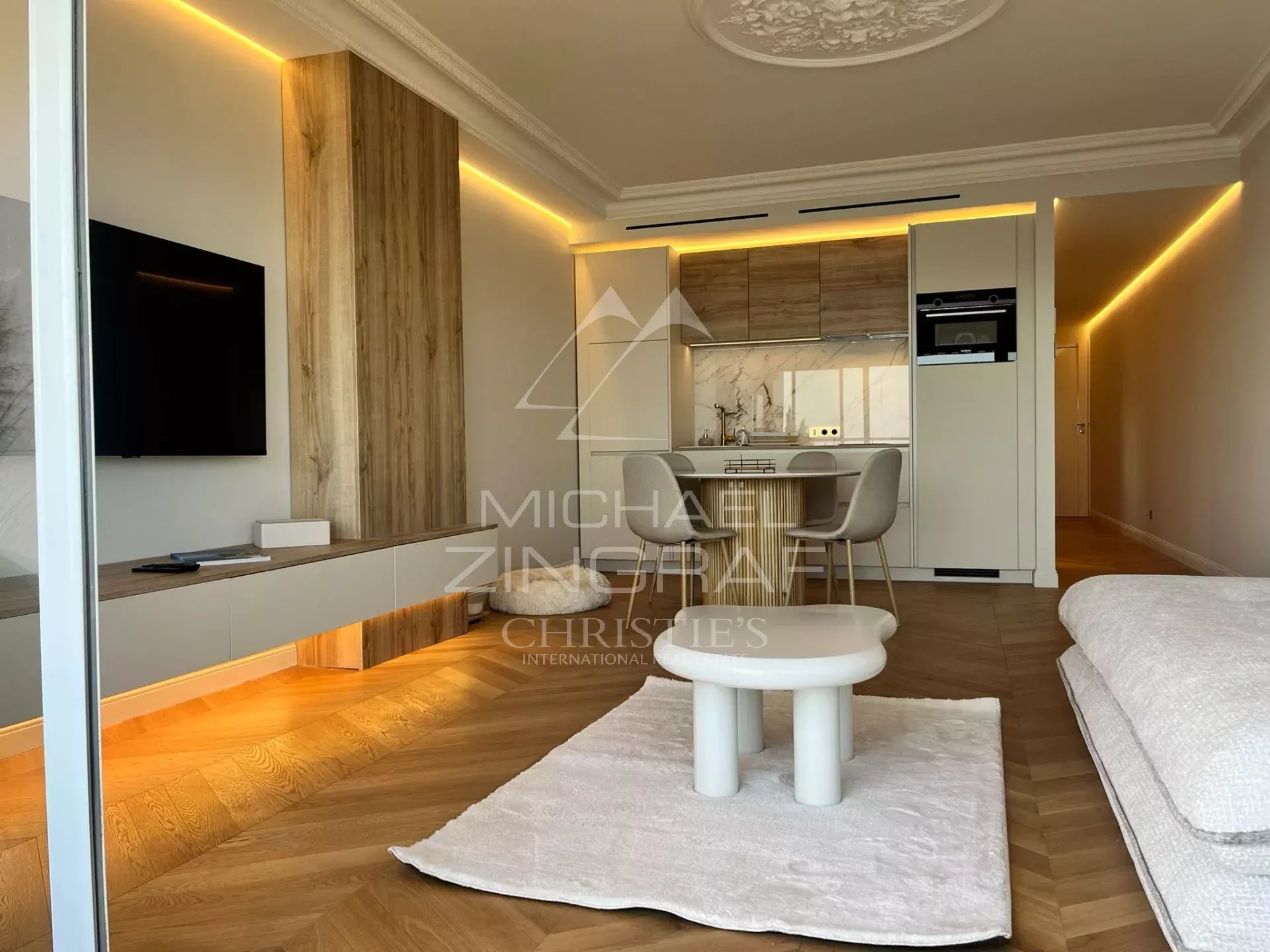 Interior of a modern apartment with living room, open kitchen and contemporary furniture in Cannes.
