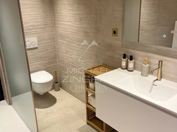 Modern bathroom with shower, sink and toilet in a renovated apartment in Cannes.