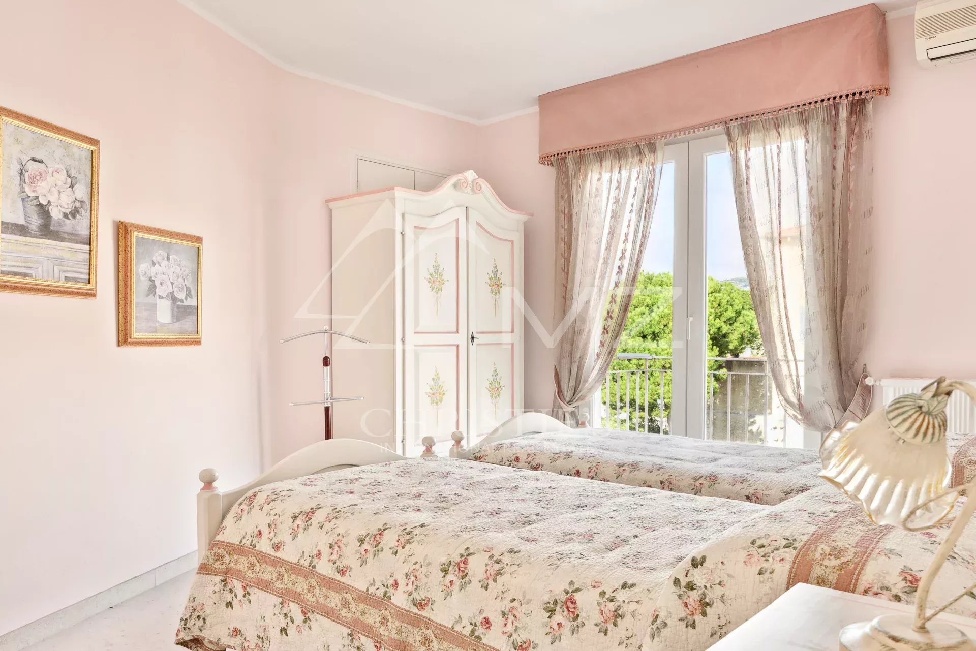 Chambre d’appartement à Cannes Chambre d'un appartement à Cannes avec lits jumeaux et décoration pastel.