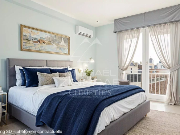 Chambre d'un appartement à Cannes avec lit double, décoration moderne et balcon.