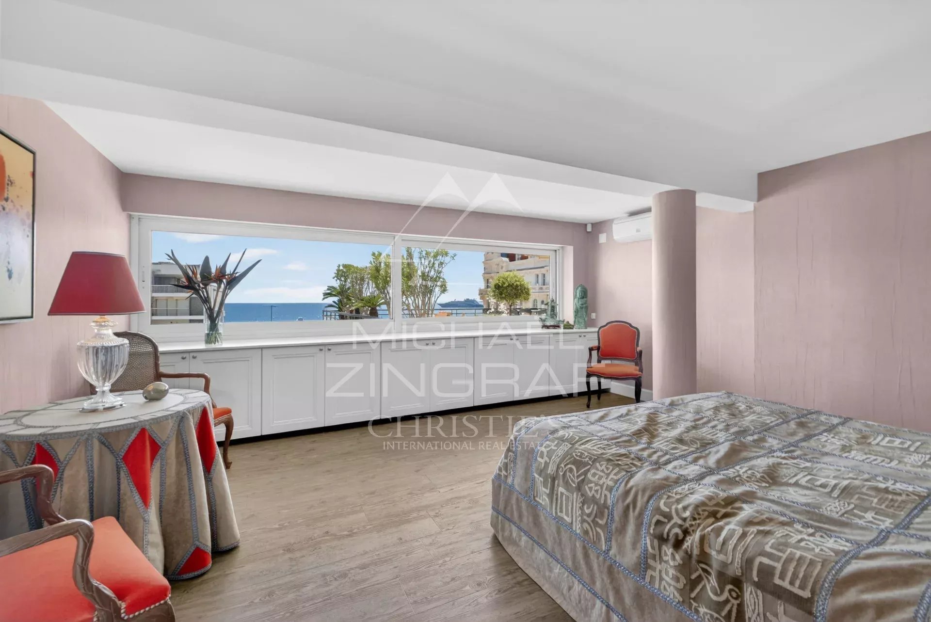 Room in a Cannes apartment with sea view and elegant decor.