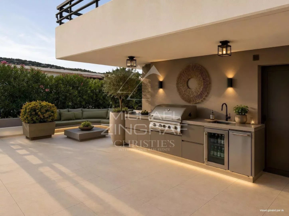 Spacious terrace of an apartment in Cannes with sea view and kitchenette.