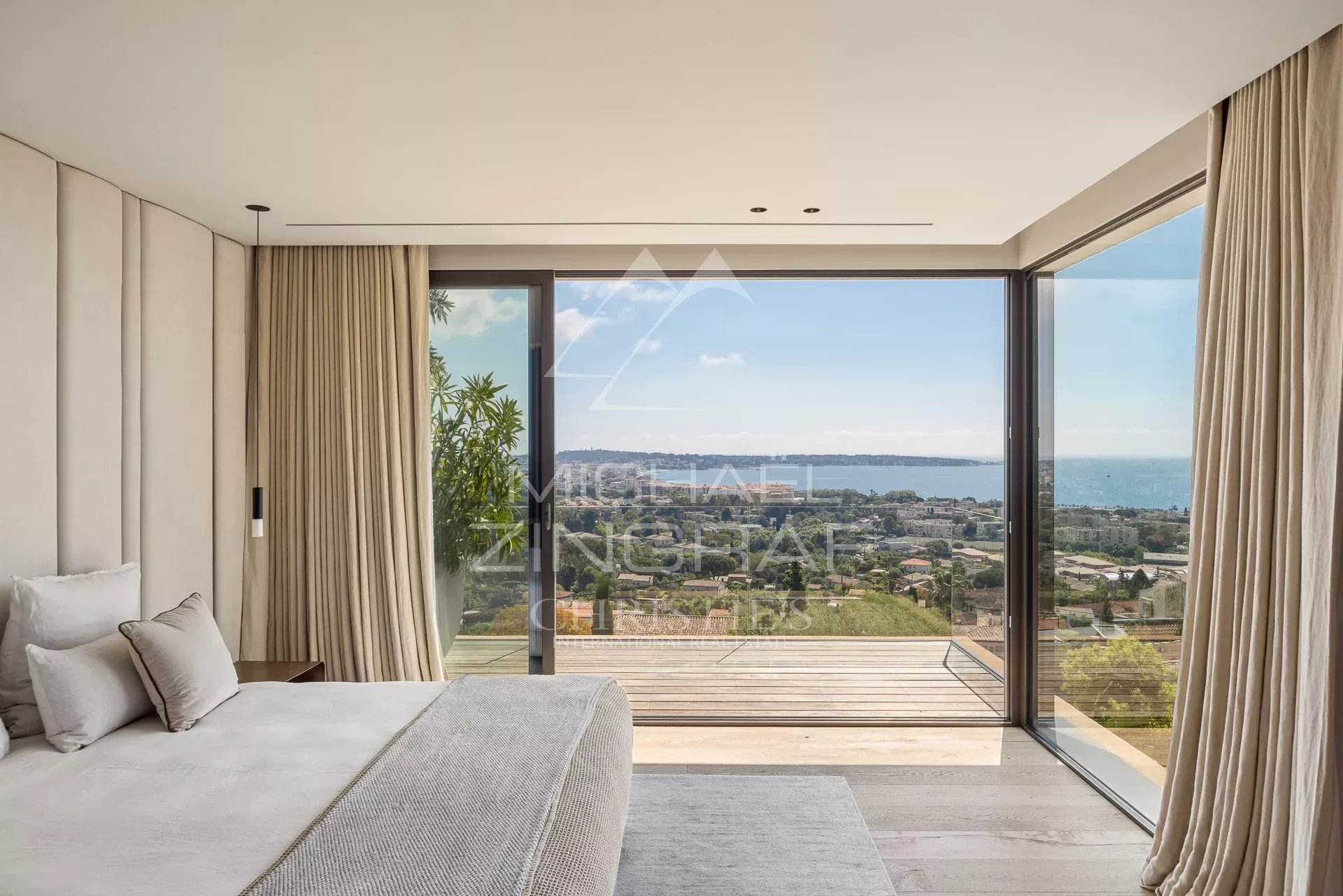 Chambre avec vue mer à Cannes Chambre moderne avec vue sur la mer à Cannes, grandes fenêtres et décoration épurée.
