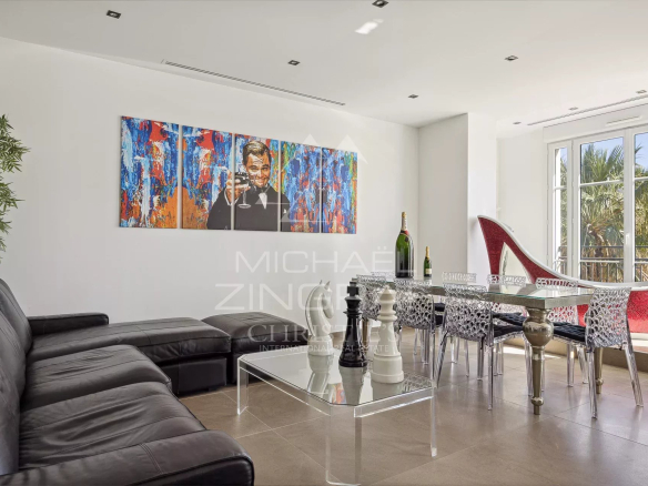 Interior of a renovated penthouse in Cannes with a modern living room and artistic decoration.