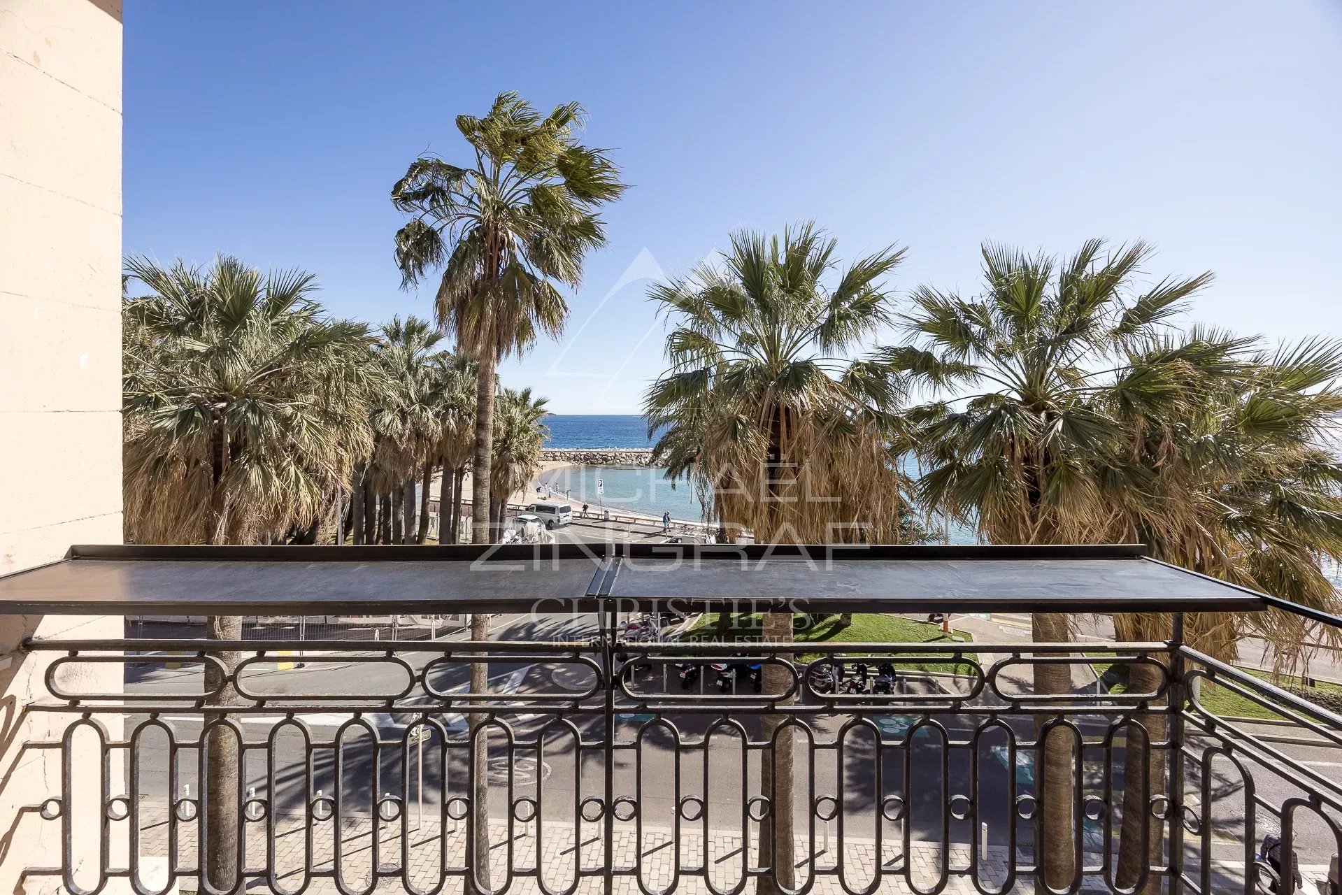 Vue mer depuis le penthouse à Cannes Vue depuis un balcon avec des palmiers et la mer en arrière-plan à Cannes.