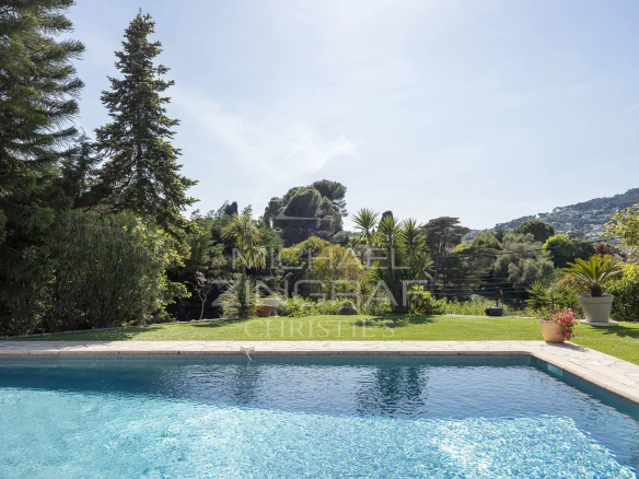View of the swimming pool and garden of a villa in a gated community in Antibes.