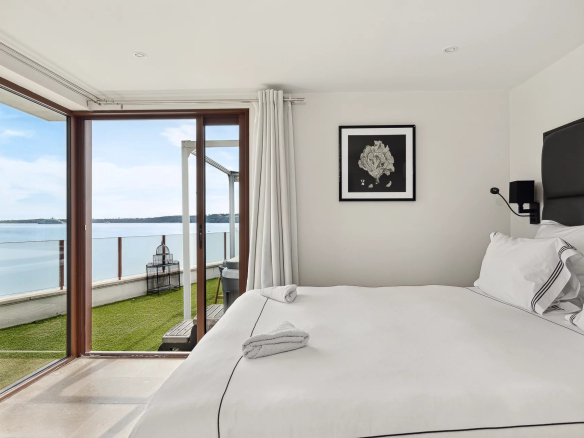 Bright room with sea view, open windows and modern decor.