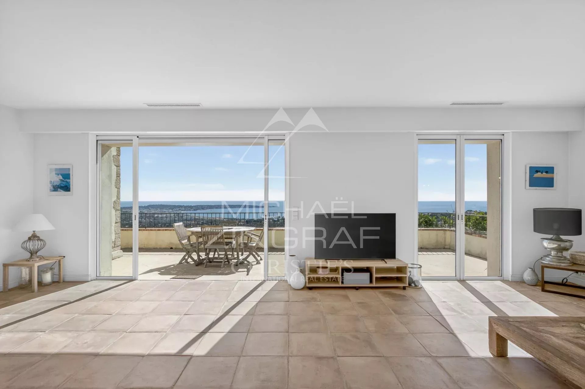 Interior of a villa in Vallauris Interior of a stone villa with sea views, bright living room and access to a terrace.