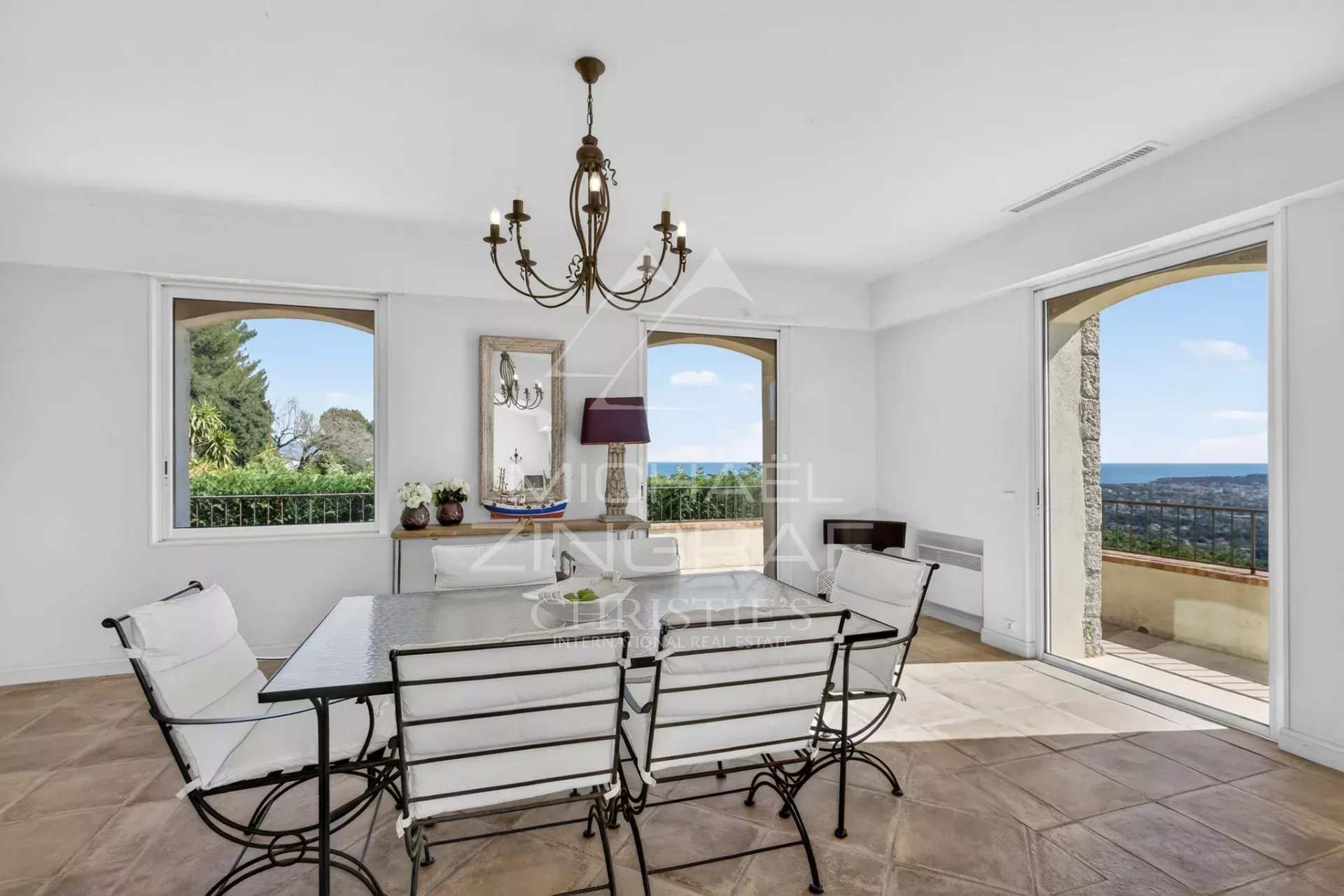 Interior of a villa with sea view Interior of a stone villa with sea view, dining table and open windows.