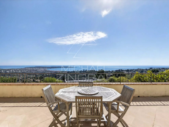 Terrace of a stone villa with panoramic views of the sea and surrounding landscape in Vallauris.