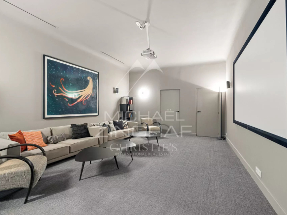 Intérieur d'une maison avec un salon moderne et une œuvre d'art au mur.