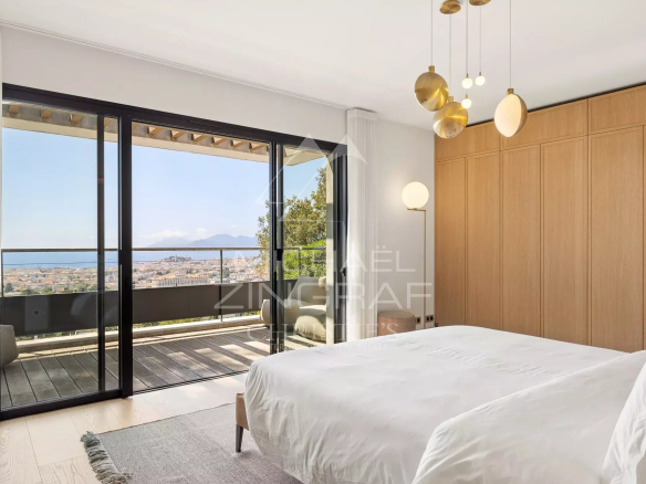 Room in a contemporary villa in Cannes with sea view and access to a balcony.