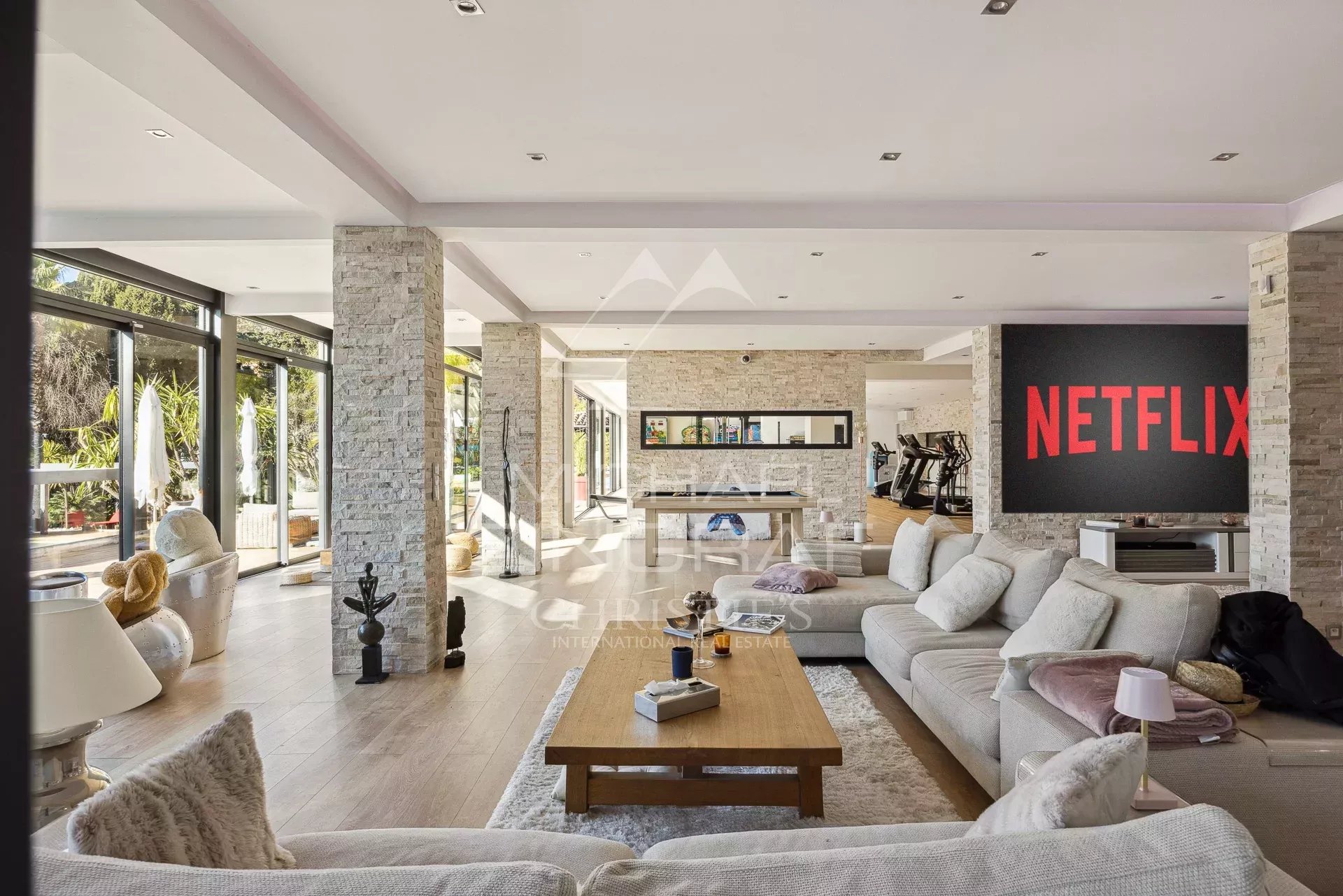 Bright living room of a villa in Cannes Interior of a modern villa in Cannes with a bright living room and Netflix screen.