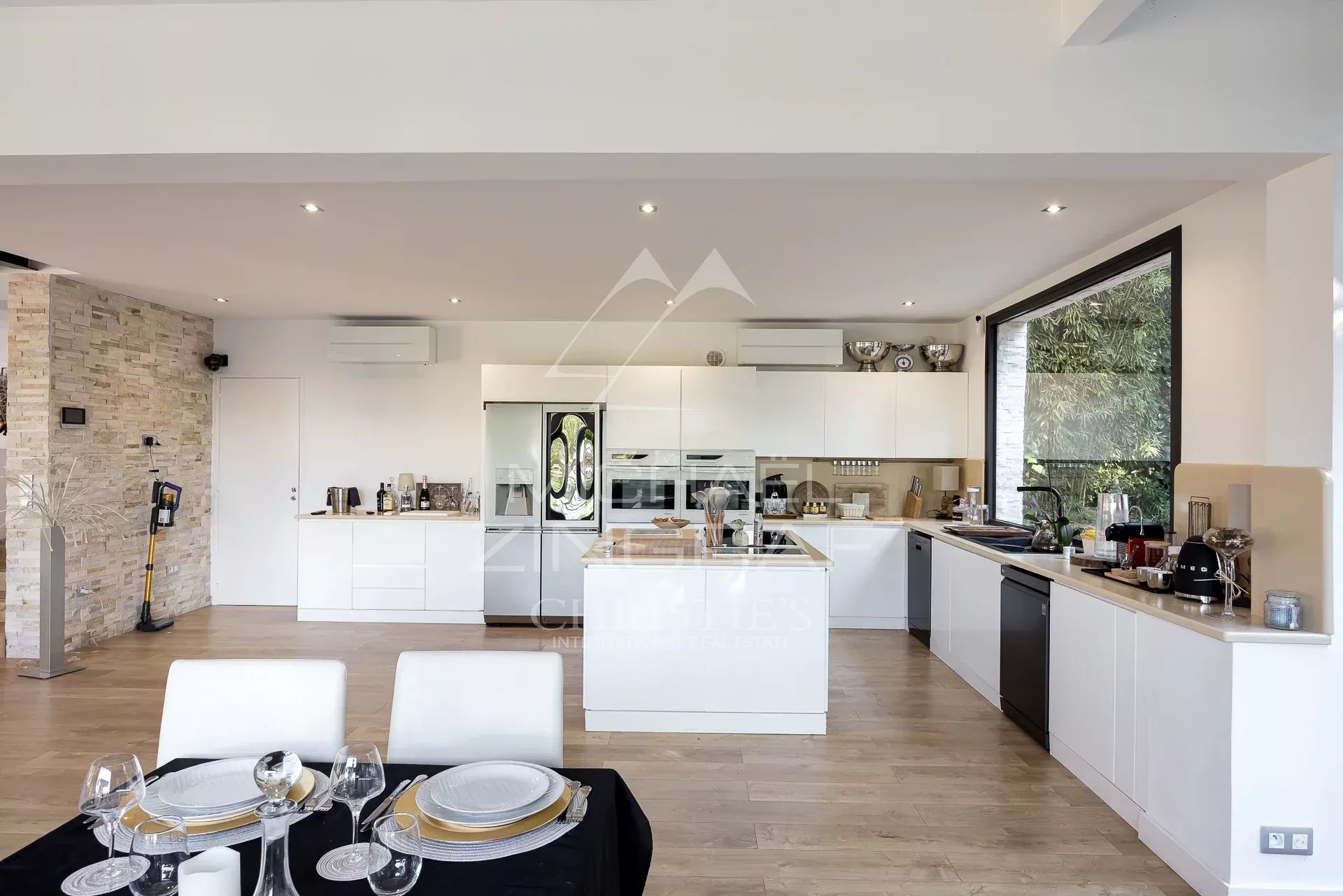Modern cuisine in Cannes Interior of a modern and bright kitchen with dining table, overlooking the sea in Cannes.