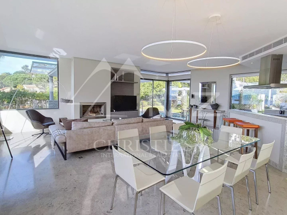 Interior of a contemporary villa in Cannes with sea views, modern living room and dining room.