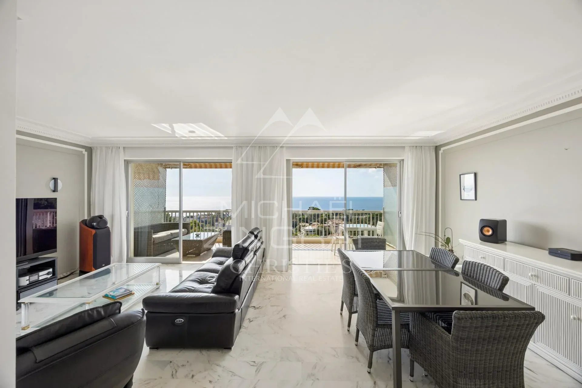 Penthouse à Cannes Intérieur d'un penthouse à Cannes avec vue sur la Méditerranée, salon lumineux et mobilier moderne.