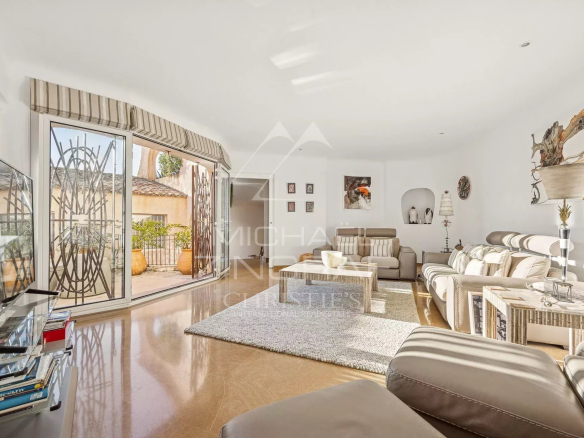 Bright interior of a villa with modern living room and access to a terrace.