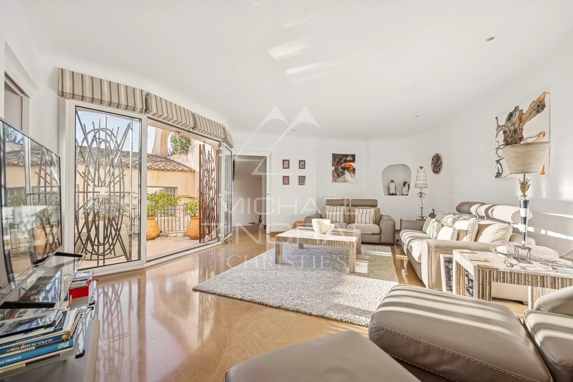 Bright interior of a villa with modern living room and access to a terrace.