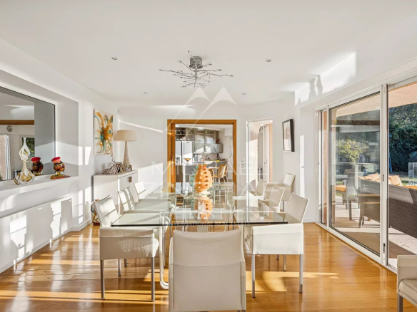Interior of a modern villa with a bright dining room and sea view.