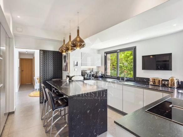 Modern kitchen with central island and contemporary appliances, villa in Cannes Eden