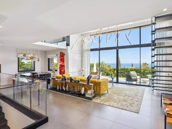 Interior of a modern villa with panoramic sea views in Cannes, bright living room and contemporary decor.
