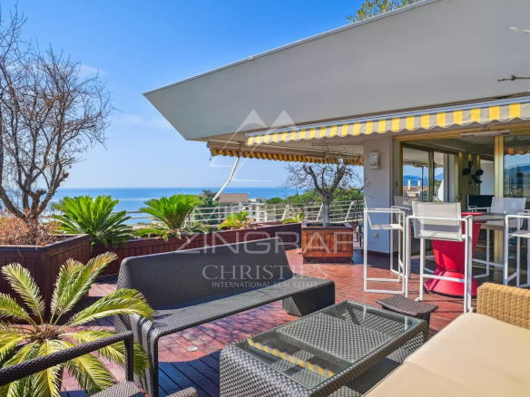 Sunny terrace with panoramic views of the Mediterranean Sea in Cannes.