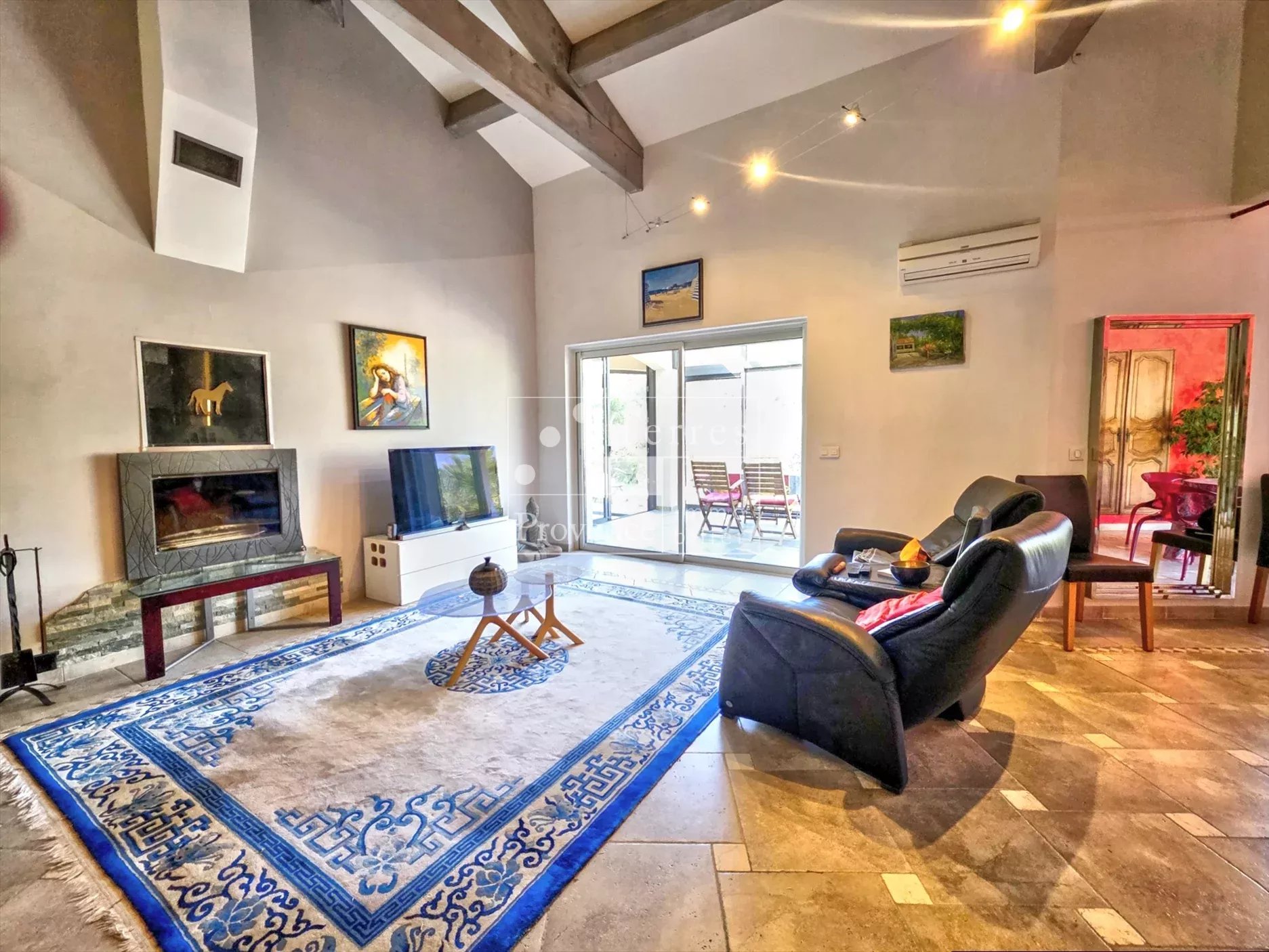 Intérieur de villa à Baudinard-sur-Verdon Intérieur d'une villa spacieuse avec salon, cheminée et accès à une terrasse.