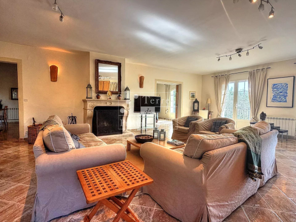 Interior of a Provençal country house with a spacious living room and fireplace.
