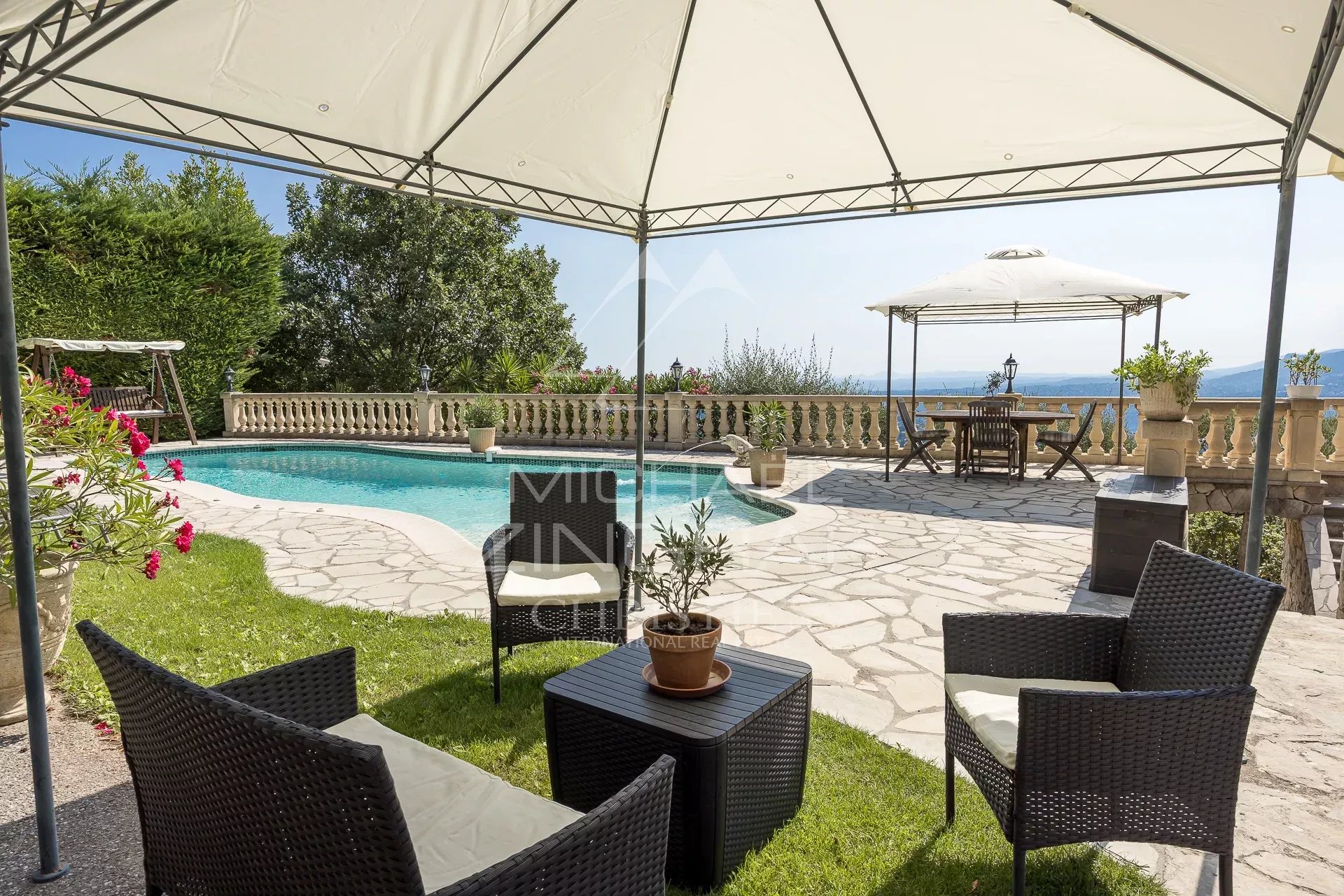 Terrace with swimming pool and garden furniture, panoramic view of the valley in Aspremont.