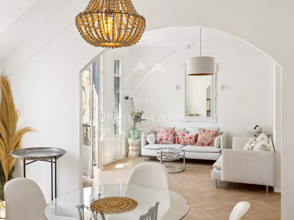 Interior of a bohemian chic apartment with sea views in Nice, bright living room and floral decor.