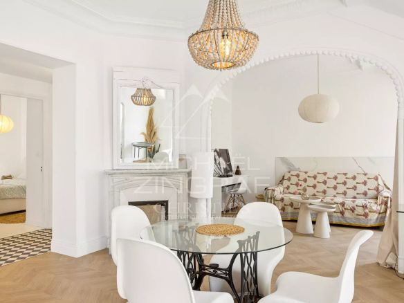 Interior of a bohemian chic apartment with a side view of the sea, in Nice.