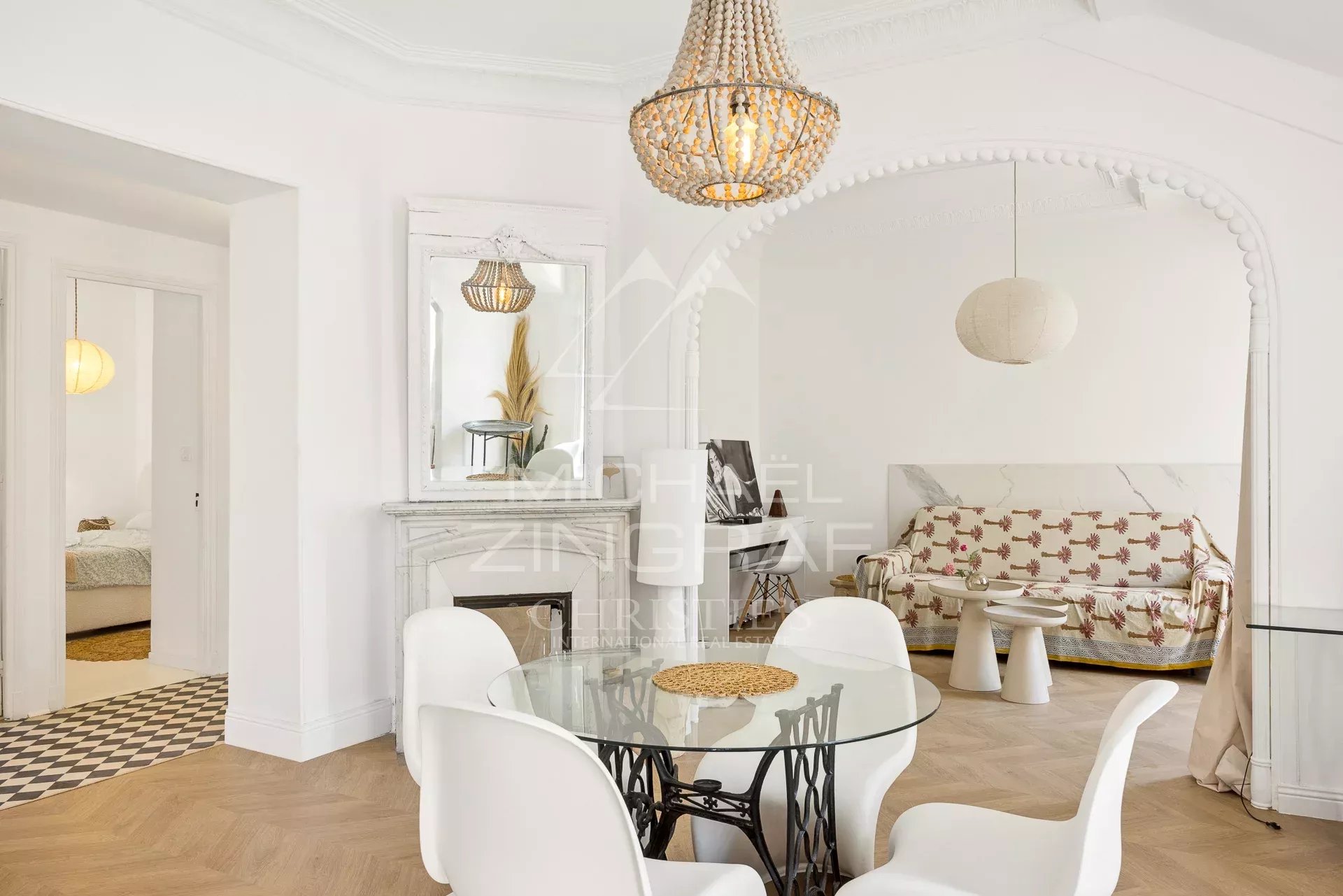 Interior of a bohemian chic apartment with a side view of the sea, in Nice.